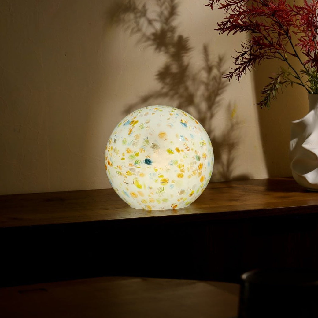 Hand-blown borosilicate glass globe lamp, close detail of the surface